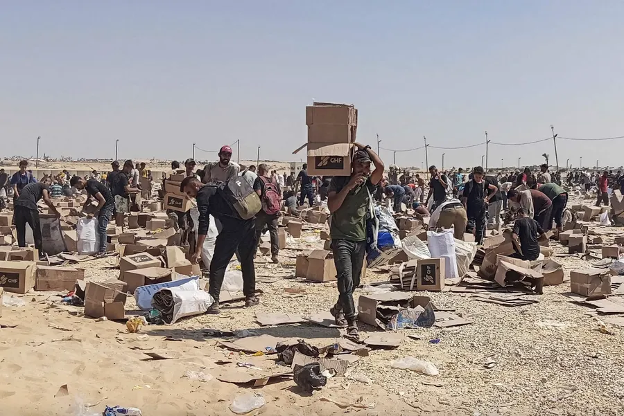 Palestinians gather to collect what remains of relief supplies